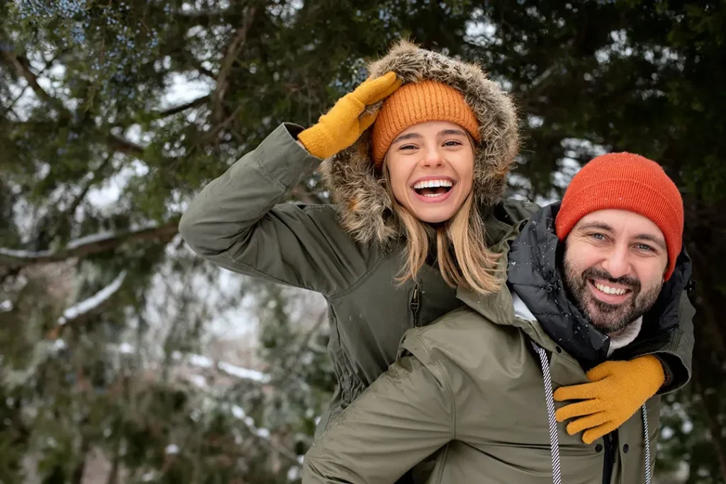 Happy couple in winter clothing, symbolizing common-law partner sponsorship in Canada