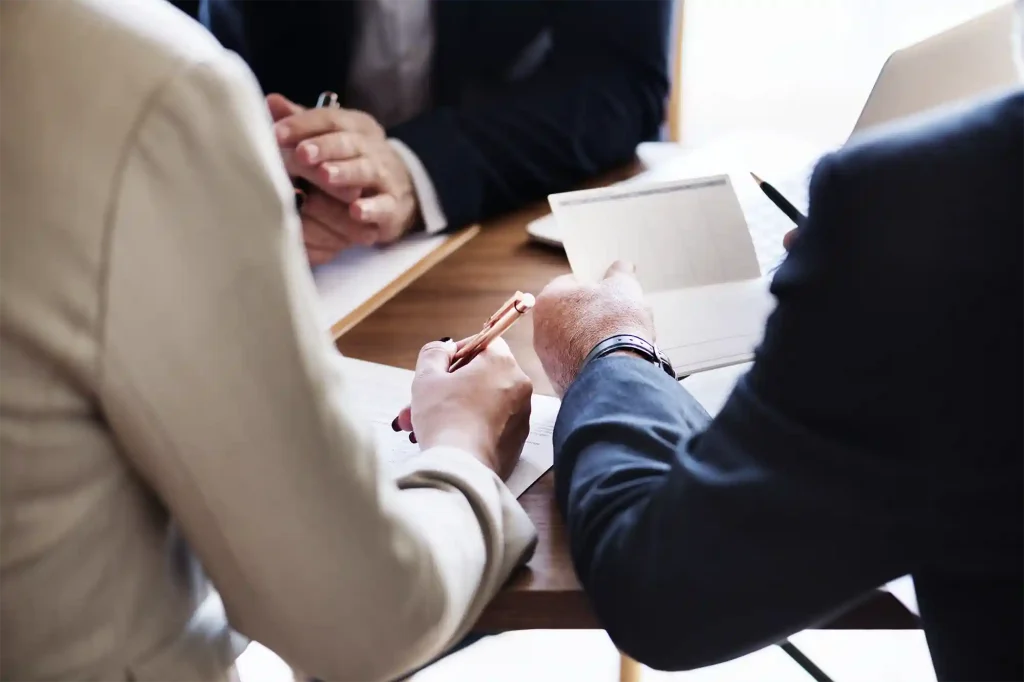 Personalized-Immigration-Case-Review-and-Support Group of people reviewing immigration case files during a meeting, symbolizing professional and personalized immigration guidance.
