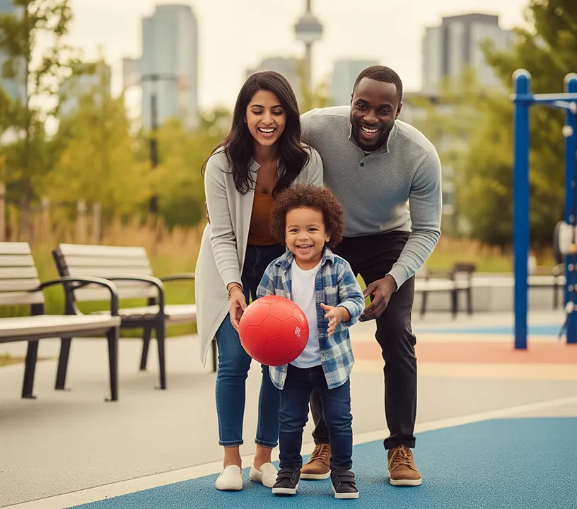 A happy family with Canadian roots plays together at a city park—reflecting the stability and full rights gained through Immigration Pros’ Canadian Citizenship Program for permanent residents.